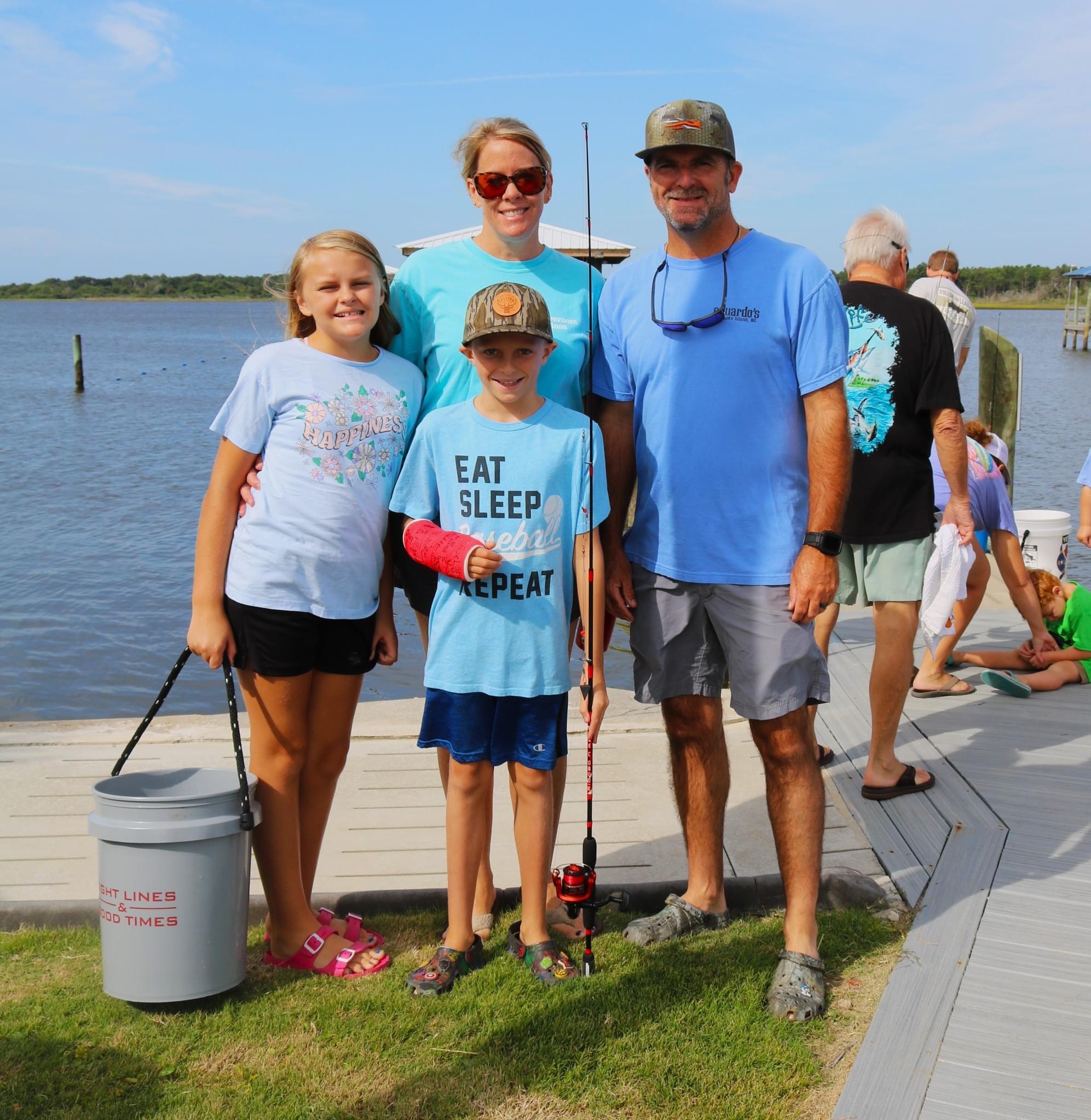 Family fishing trip with a bucket and rod.