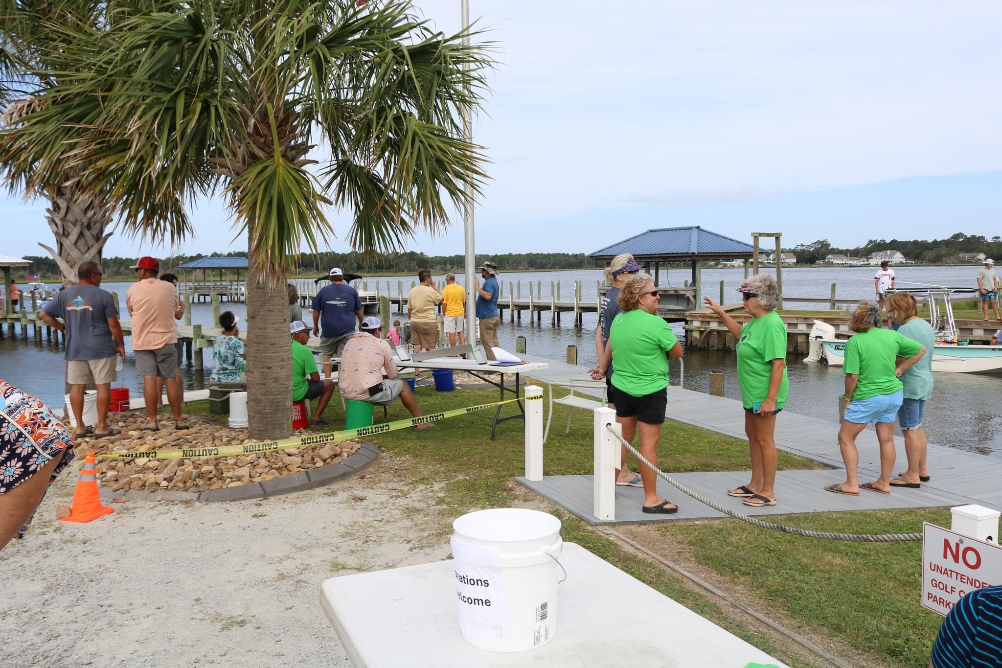 People gather at a dock by the water.
